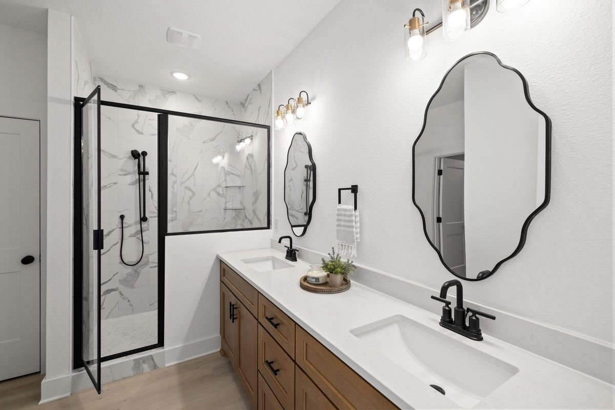 Primary bath with a glass shower and black fixtures